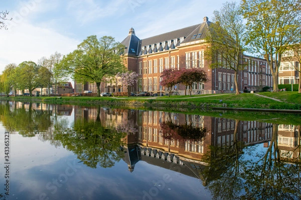 Fototapeta The old library in the city of Delft viewed from the canal.