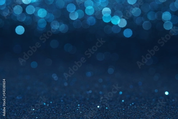 Fototapeta blue Sparkling Lights Festive background with texture. Abstract Christmas twinkled bright bokeh defocused and Falling stars. Winter Card or invitation	