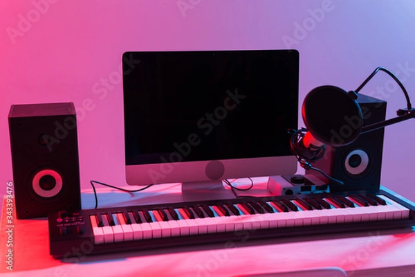 Fototapeta Microphone, computer and musical equipment guitars and piano background. Home recording studio concept.
