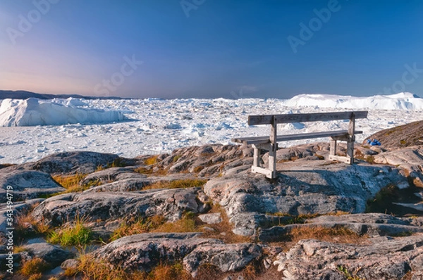 Fototapeta The lonely bench on the hiking trail to Sermermiut, Greenland. Sermermiut was an Inuit settlement near the town of Ilulissat, in the Disko Bay. Here, in front of the Icefjord stay this famous bench