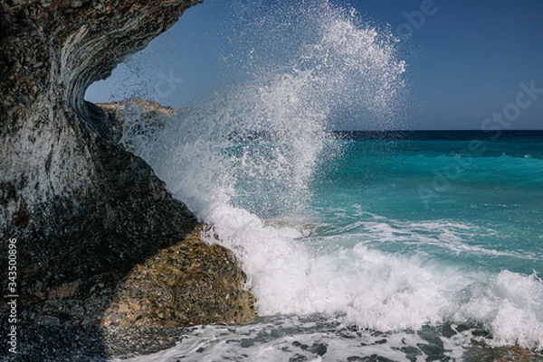 Obraz Sea wave hits a rock.
