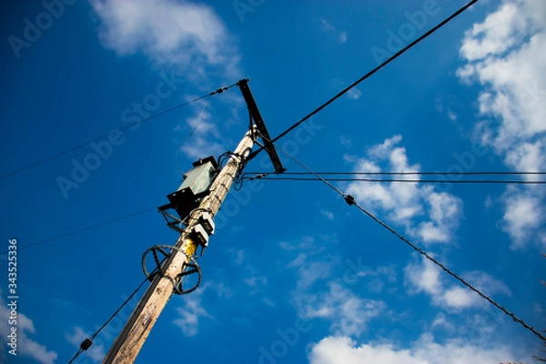 Fototapeta High voltage power lines against blue sky
