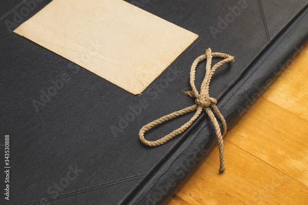 Fototapeta Vintage folder for paper with blank label. old folder for documents lies on a wooden table