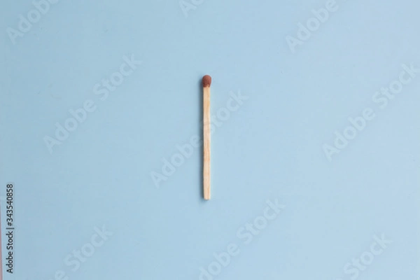 Fototapeta Match on a blue background, the concept of fire, fire, fire, fire, heat, heating. Card with copy space for text