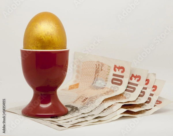 Obraz Golden Egg in an egg cup with money