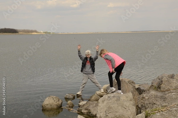 Fototapeta 
Family outdoor activities. Children play on the lake.
