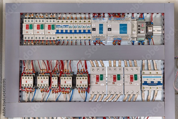 Fototapeta Motor protection circuit breakers, remote access controller, phase and voltage control relays, thermostat and contactors with front additional contacts in the electrical Cabinet.