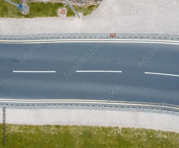 Fototapeta An empty highway road from above, empty due to the coronavirus lockdown during the corona virus covid 19 epidemic pandemic. Empty public spaces enforced by the government.