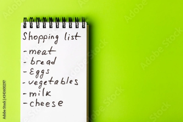 Fototapeta  Shopping list for the supermarket on a green background.
