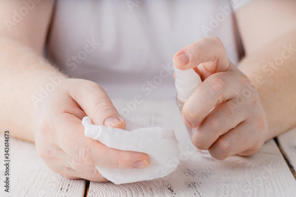 Fototapeta hands using bottle of hand sanitizer, hand desinfectant. preventing virus infection during epidemic or pandemic