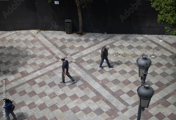Obraz Aerial view of pedestrians in the streets of Madrid during the quarantine of the COVID19 health crisis. Montera street in Madrid, Spain.