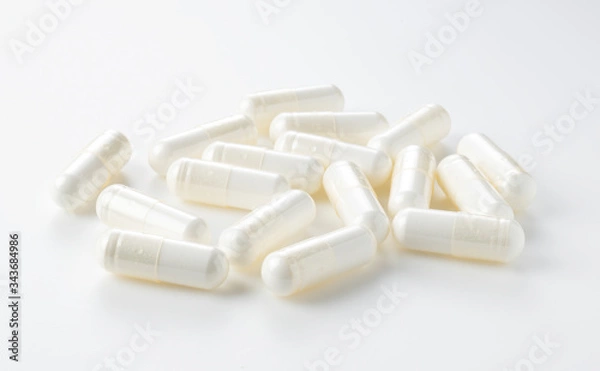 Obraz White capsules placed on a white background