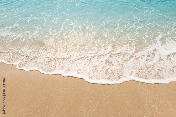 Fototapeta wave of blue ocean on sandy beach. texture Background.