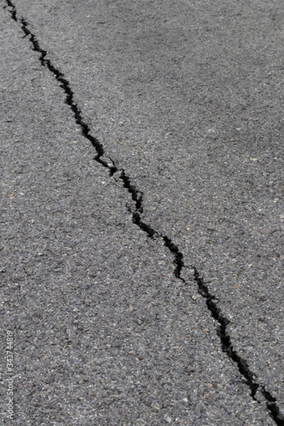 Fototapeta The surface asphalt cracking linear curve.