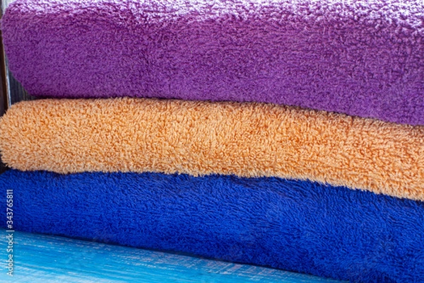 Fototapeta Stack of clean towels on bed