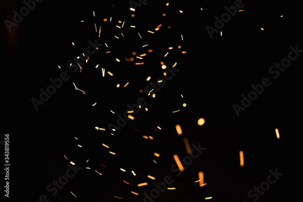 Obraz Group of flying sparks in the black background