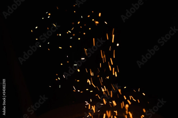 Obraz Group of flying sparks in the black background