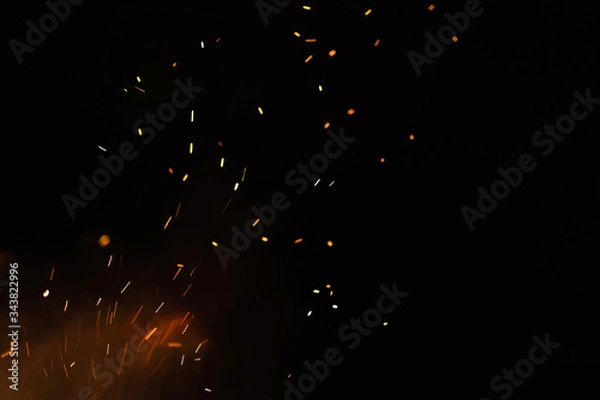 Obraz Group of flying sparks in the black background