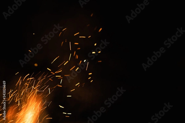 Obraz Group of flying sparks in the black background