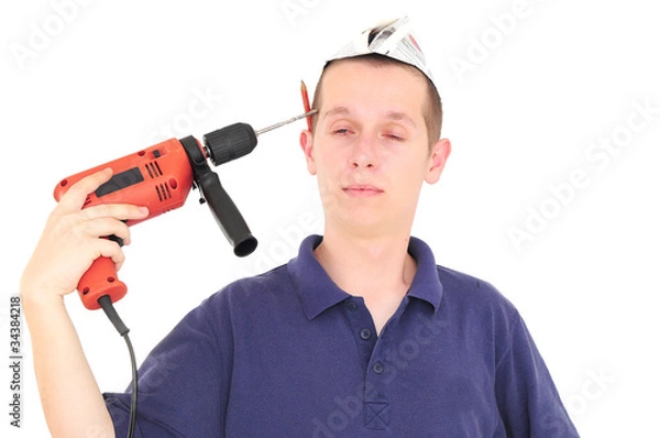 Obraz Young worker putting the drill into his head