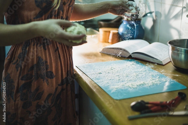 Fototapeta Dusting a surface with flour