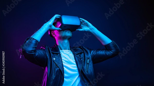 Fototapeta Handsome young man using a virtual reality headset