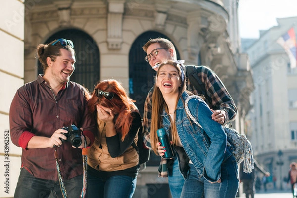 Fototapeta Group of tourists sightseeing the city