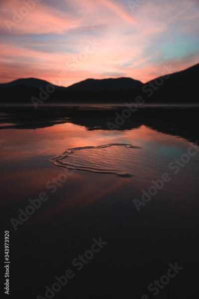 Fototapeta Sunrise over a beach at low tide 