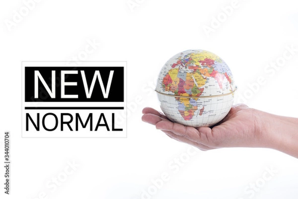 Obraz NEW NORMAL text on Globe in hand isolated on white background