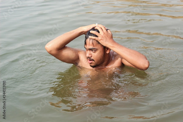 Obraz young man model bathing in a river