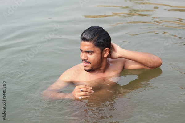 Obraz young man model bathing in a river