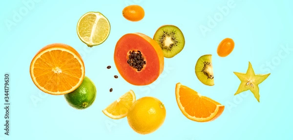Fototapeta Flying fruits healthy summer background. Papaya, orange, kiwi, melon. Levitation, falling fly fruit on blue. Tropical creative concept. Colorful fruity summertime vivid design