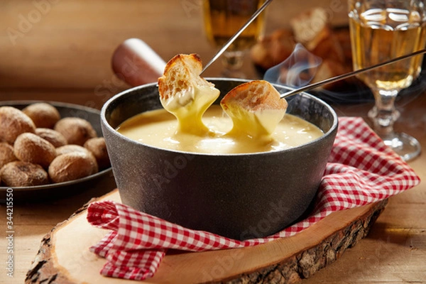 Obraz Steaming hot cheese fondue served with wine