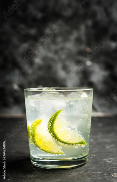 Obraz Rum based cocktail caipirinha (variation of cuba libre) on the rustic background. Selective focus. Shallow depth of field.