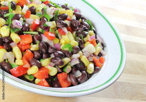 Fototapeta Southwest Black Bean Salad in a bowl sitting on a table.