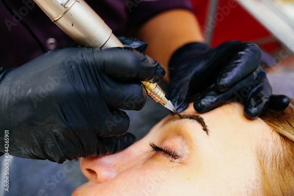 Obraz the eyebrow spraying process in the technique of powdery, nano permanent makeup.