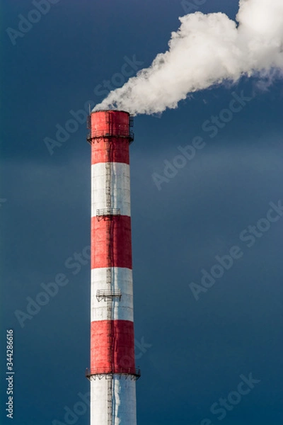 Fototapeta The pipe of the plant emits harmful substances into the atmosphere. Close up on a sky background