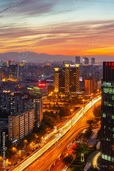 Obraz Warm sunset over a modern city with a lot of traffic