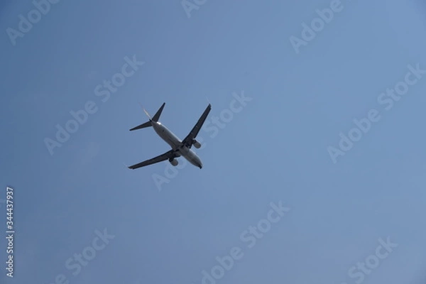 Obraz Plane flying in the sky seen from below