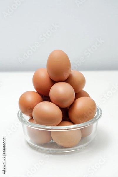 Fototapeta Eggs in a transparent glass bowl. A bowl of eggs