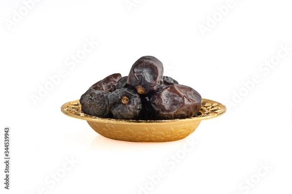Obraz Ajwa Dates fruits or dry dates isolated on white background.Ramadan Kareem Breaking the fast by eating Tamar Dates