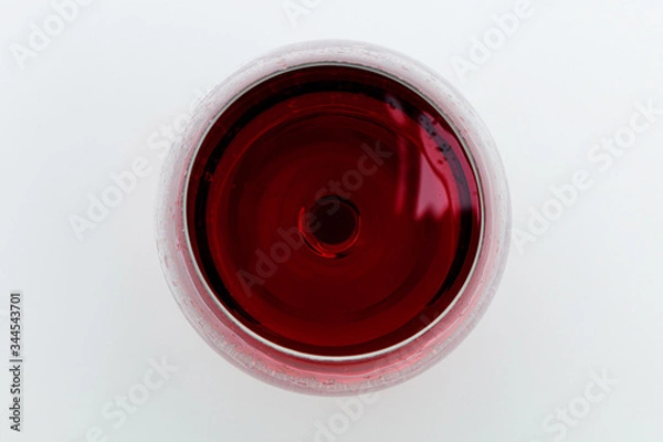 Fototapeta Glass of red wine on a white background. View from above