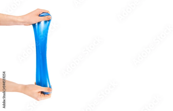 Obraz Blue slime stretchable toy for children in hands. An elastic antistress toy for relaxation. Gum for hands. Funny Games. Slime isolated. Copy space, place for text.