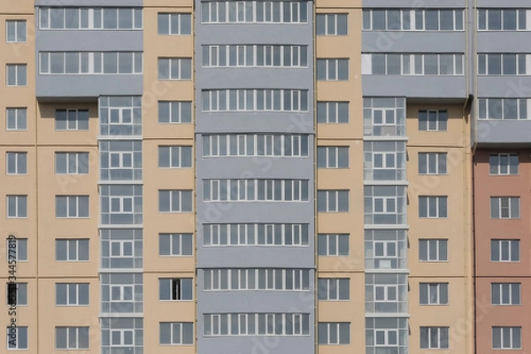 Fototapeta Apartment building. Facade of a multi-storey building.