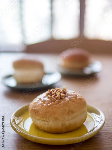 Obraz Close up doughnuts on ceramic plates. Concept for cafe vibe.(selective focus)