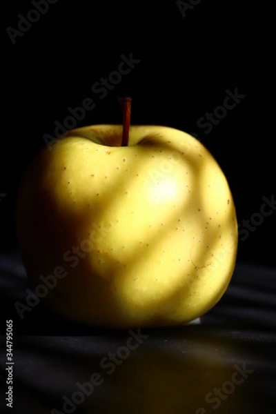 Obraz golden apple on black background