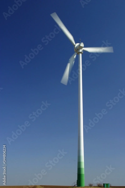 Fototapeta Wind turbines generating power on green field