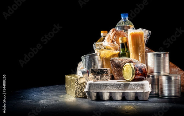 Fototapeta Food donations of different products on dark background, top view with copy space