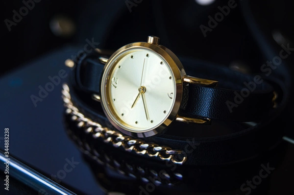 Fototapeta Watch with a leather strap and chain round dial in black and blue colors with space for text background