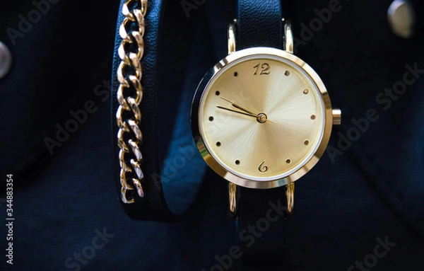 Fototapeta Watch with a leather strap and chain round dial in black and blue colors with space for text background
